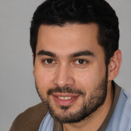 Joyful white young-adult male with short  black hair and brown eyes