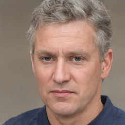 Joyful white middle-aged male with short  brown hair and brown eyes