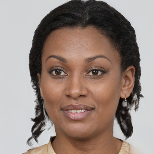 Joyful black young-adult female with short  brown hair and brown eyes