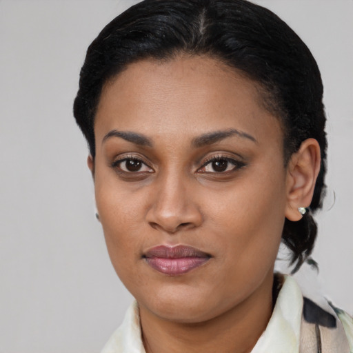 Joyful black young-adult female with short  brown hair and brown eyes