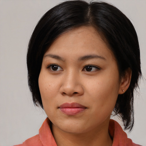 Joyful asian young-adult female with medium  brown hair and brown eyes