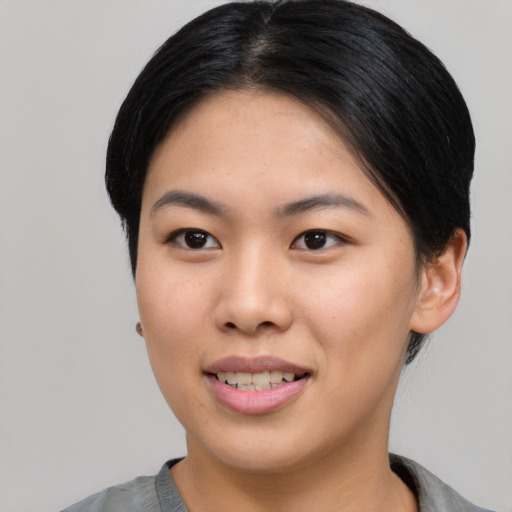 Joyful asian young-adult female with short  black hair and brown eyes