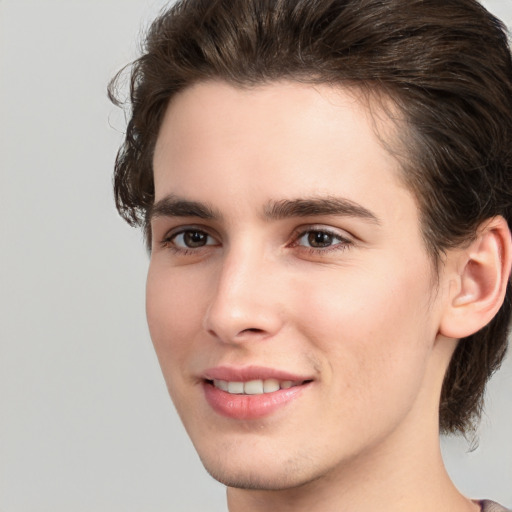 Joyful white young-adult male with medium  brown hair and brown eyes