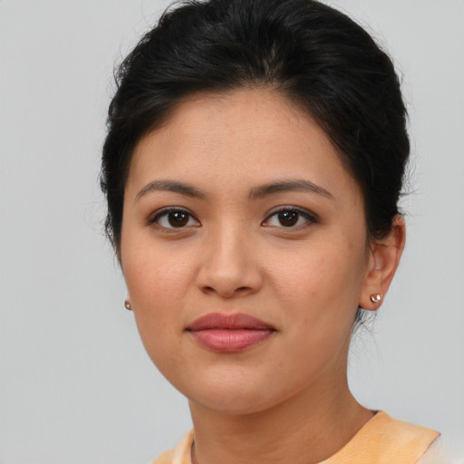 Joyful asian young-adult female with short  brown hair and brown eyes