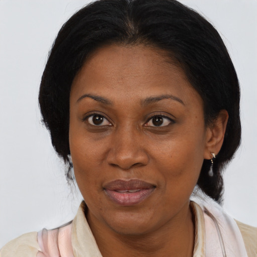 Joyful black adult female with medium  brown hair and brown eyes