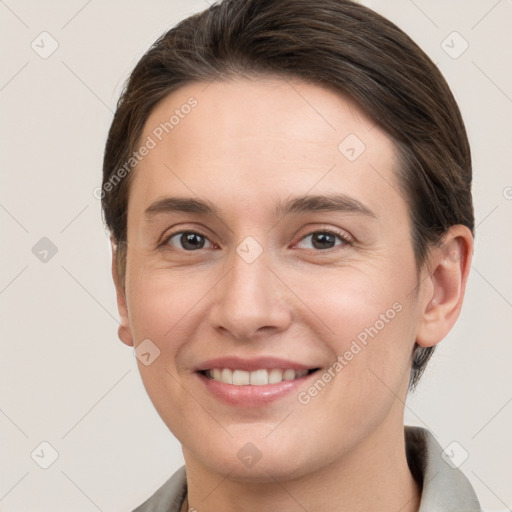 Joyful white young-adult female with short  brown hair and grey eyes