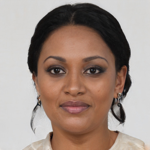 Joyful black young-adult female with medium  black hair and brown eyes