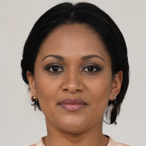Joyful black young-adult female with medium  brown hair and brown eyes