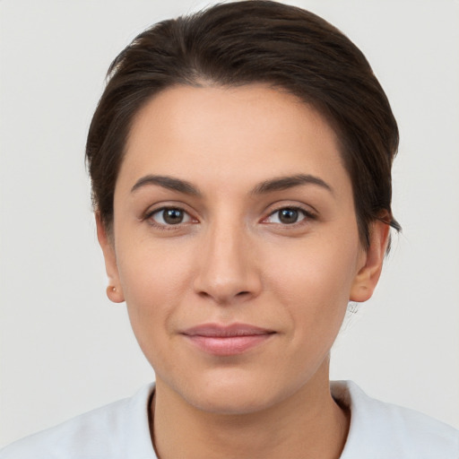 Joyful white young-adult female with short  brown hair and brown eyes