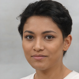 Joyful latino young-adult female with short  brown hair and brown eyes