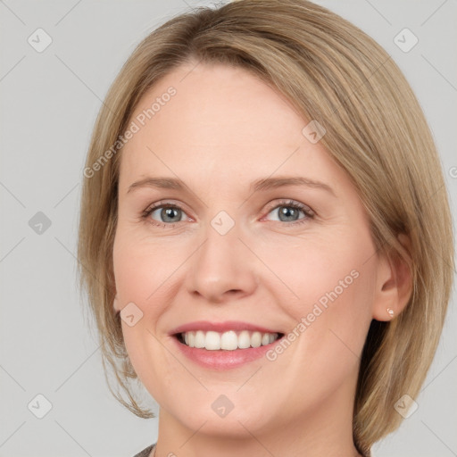 Joyful white young-adult female with medium  brown hair and blue eyes