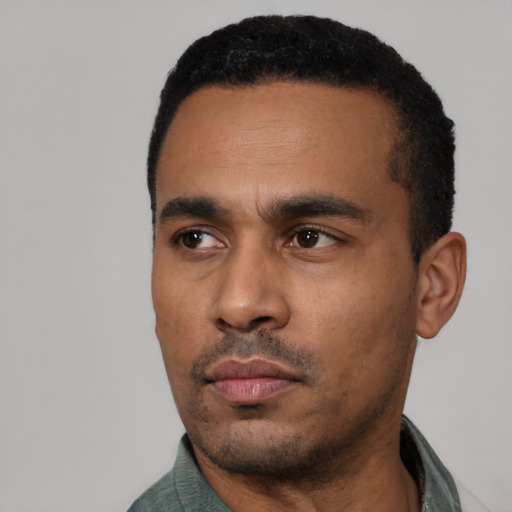 Neutral latino young-adult male with short  black hair and brown eyes
