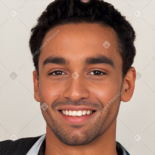 Joyful white young-adult male with short  black hair and brown eyes