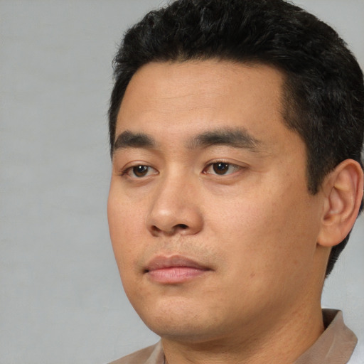 Neutral latino young-adult male with short  black hair and brown eyes