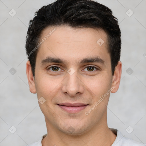 Joyful white young-adult male with short  black hair and brown eyes