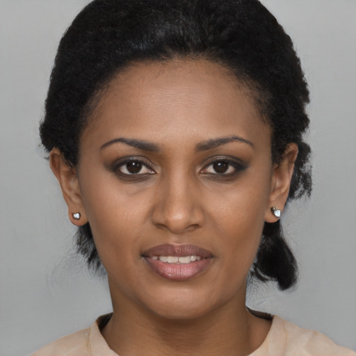 Joyful black young-adult female with short  brown hair and brown eyes