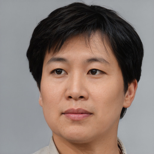 Joyful asian adult male with short  brown hair and brown eyes