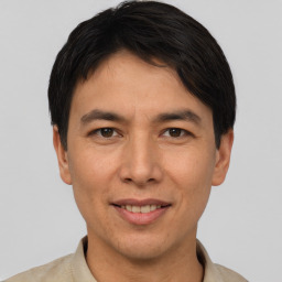 Joyful asian young-adult male with short  black hair and brown eyes