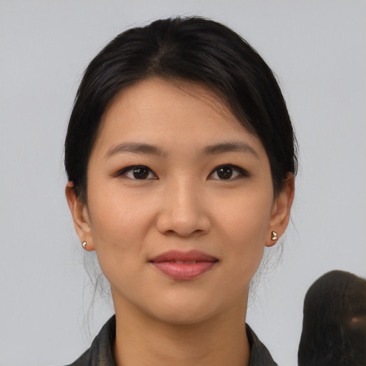 Joyful latino young-adult female with medium  black hair and brown eyes
