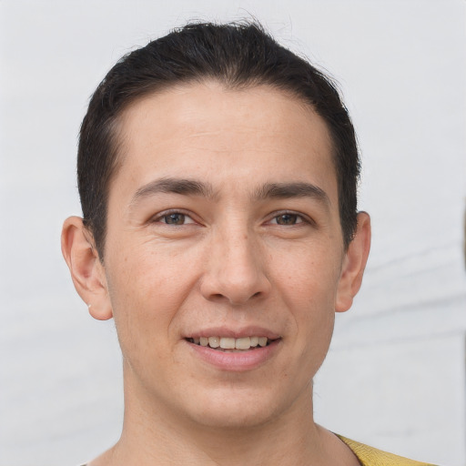 Joyful white young-adult male with short  brown hair and brown eyes