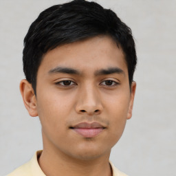 Joyful asian young-adult male with short  black hair and brown eyes