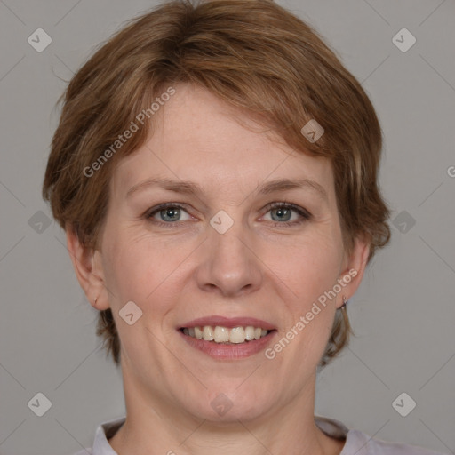 Joyful white adult female with medium  brown hair and grey eyes