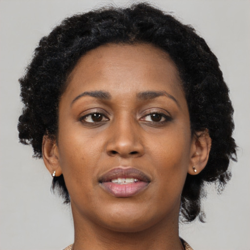Joyful black young-adult female with medium  black hair and brown eyes