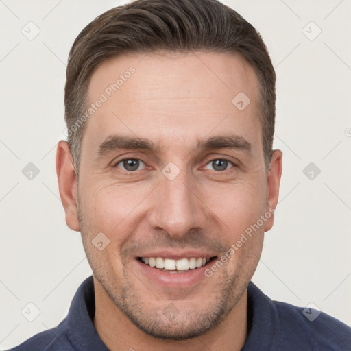 Joyful white young-adult male with short  brown hair and brown eyes