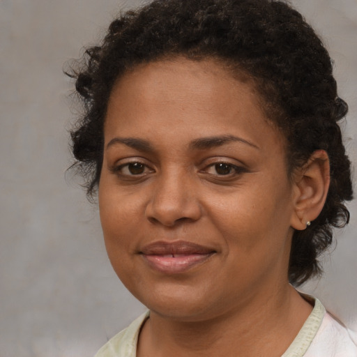 Joyful black young-adult female with medium  brown hair and brown eyes
