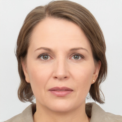 Joyful white adult female with medium  brown hair and brown eyes