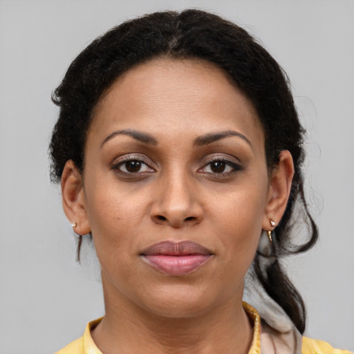 Joyful latino young-adult female with medium  brown hair and brown eyes