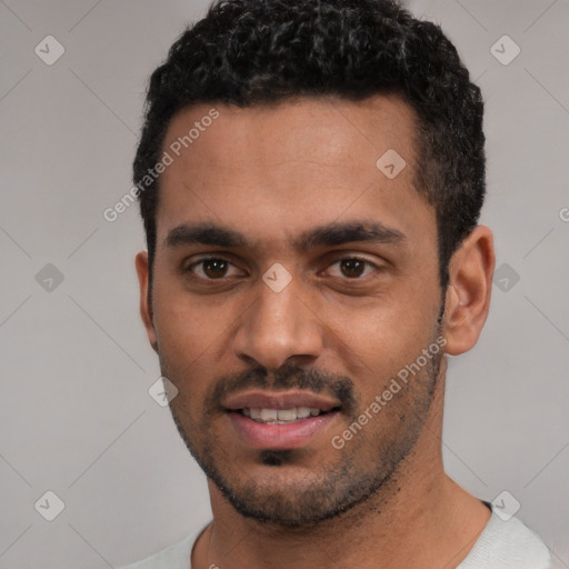 Joyful white young-adult male with short  black hair and brown eyes