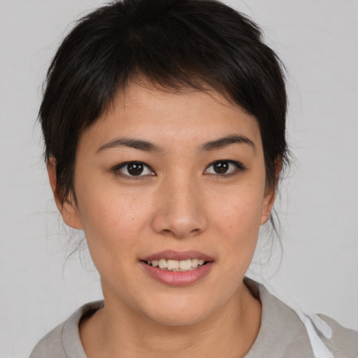 Joyful asian young-adult female with medium  brown hair and brown eyes