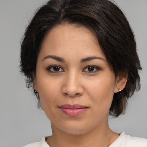 Joyful latino young-adult female with medium  brown hair and brown eyes