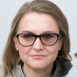 Joyful white adult female with medium  brown hair and blue eyes