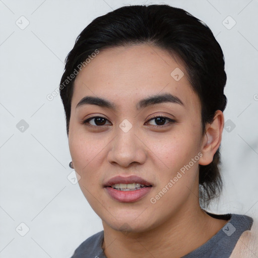 Joyful asian young-adult female with short  black hair and brown eyes