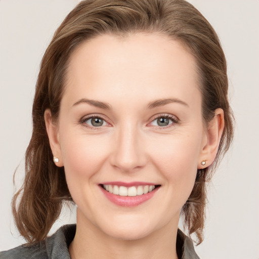 Joyful white young-adult female with medium  brown hair and blue eyes