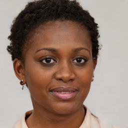 Joyful black young-adult female with short  brown hair and brown eyes