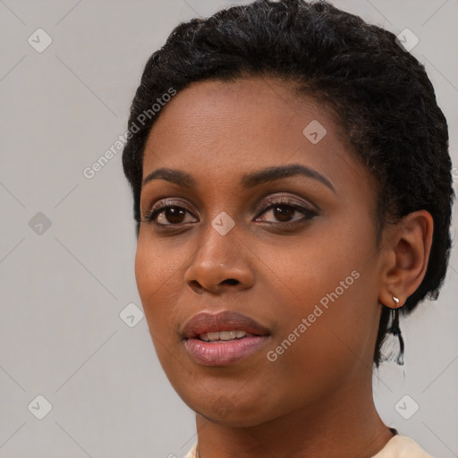 Joyful black young-adult female with short  black hair and brown eyes