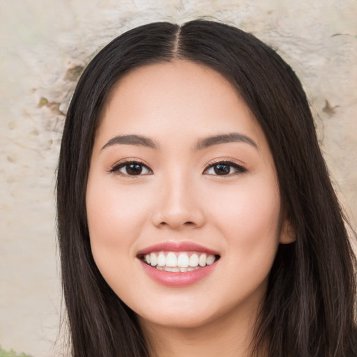 Joyful white young-adult female with long  black hair and brown eyes