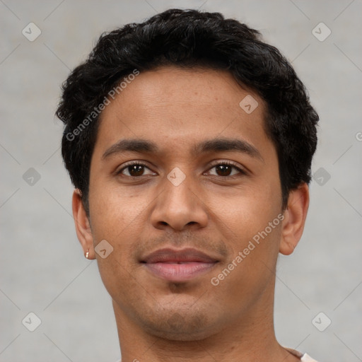 Joyful latino young-adult male with short  black hair and brown eyes