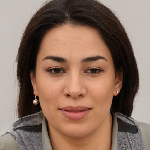 Joyful asian young-adult female with medium  brown hair and brown eyes