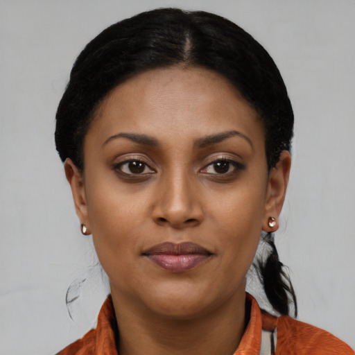 Joyful latino young-adult female with short  black hair and brown eyes