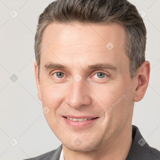 Joyful white adult male with short  brown hair and brown eyes