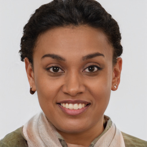 Joyful latino young-adult female with short  brown hair and brown eyes