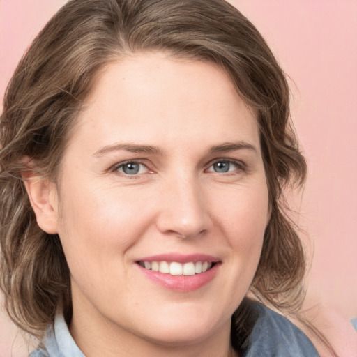 Joyful white young-adult female with medium  brown hair and blue eyes