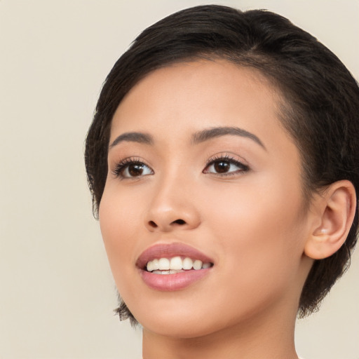 Joyful asian young-adult female with long  brown hair and brown eyes