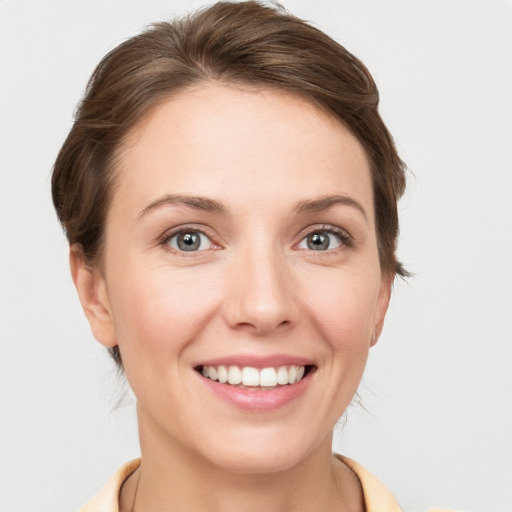 Joyful white young-adult female with medium  brown hair and grey eyes