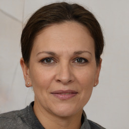 Joyful white adult female with short  brown hair and brown eyes