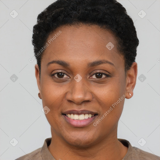 Joyful black young-adult female with short  black hair and brown eyes